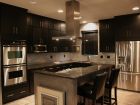 Dark Themed Kitchen with Stove Vent